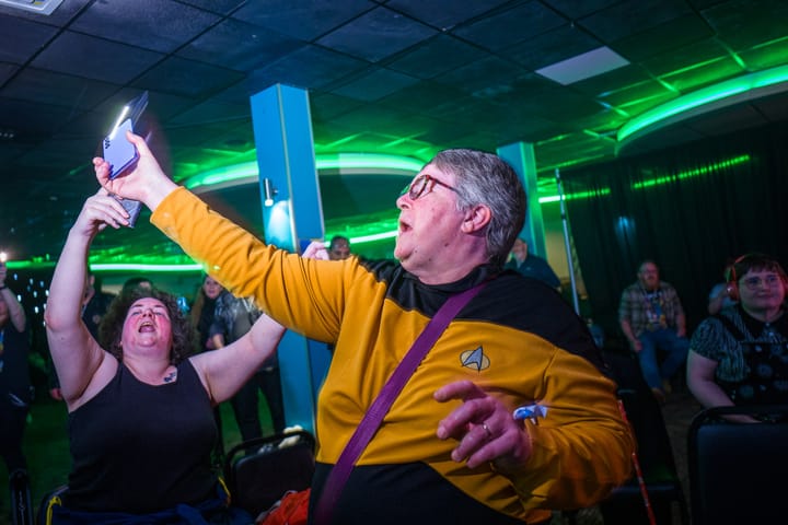 A woman dances in a TNG era engineering Starfleet uniform.