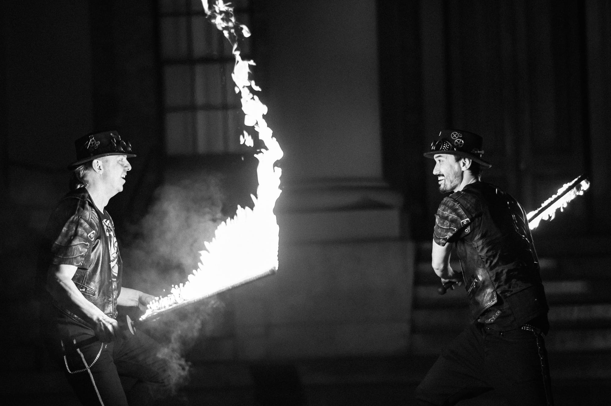 Men battle with flaming swords.