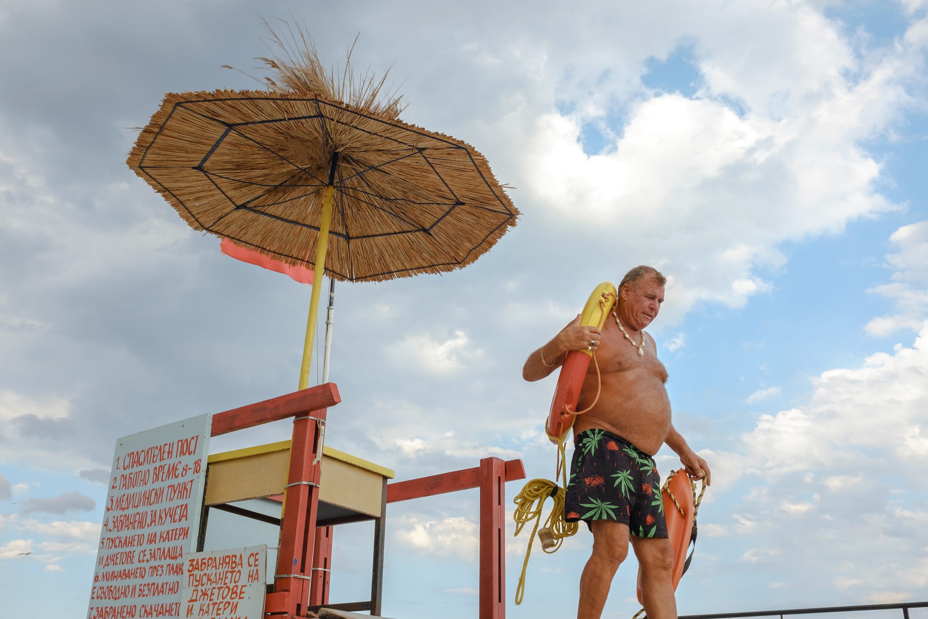 The local life guard, complete with beer belly, carries life preservers.