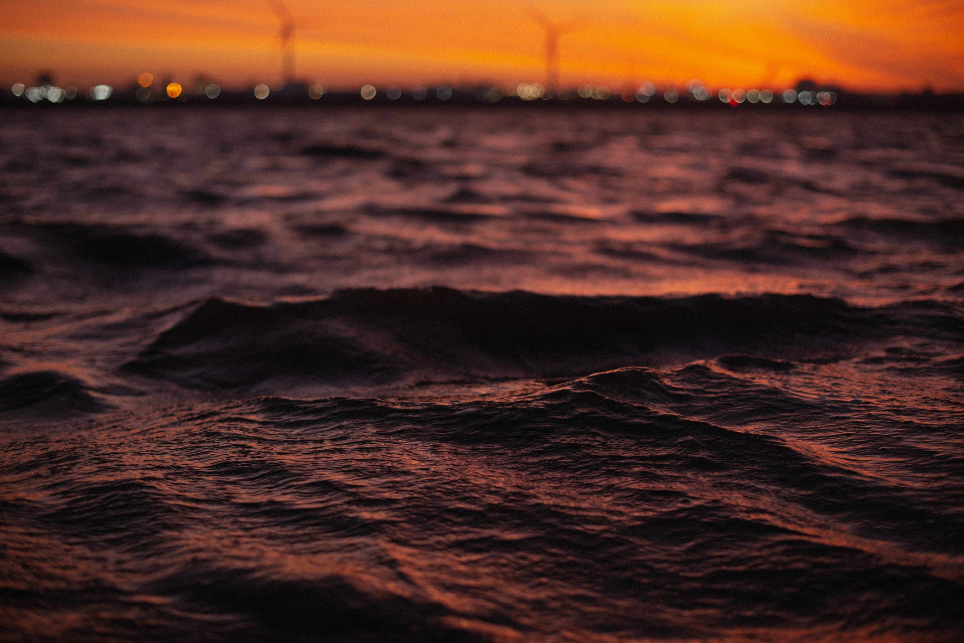 With a hint of the sky, sunrise is reflected in the choppy waves of the River Mersey