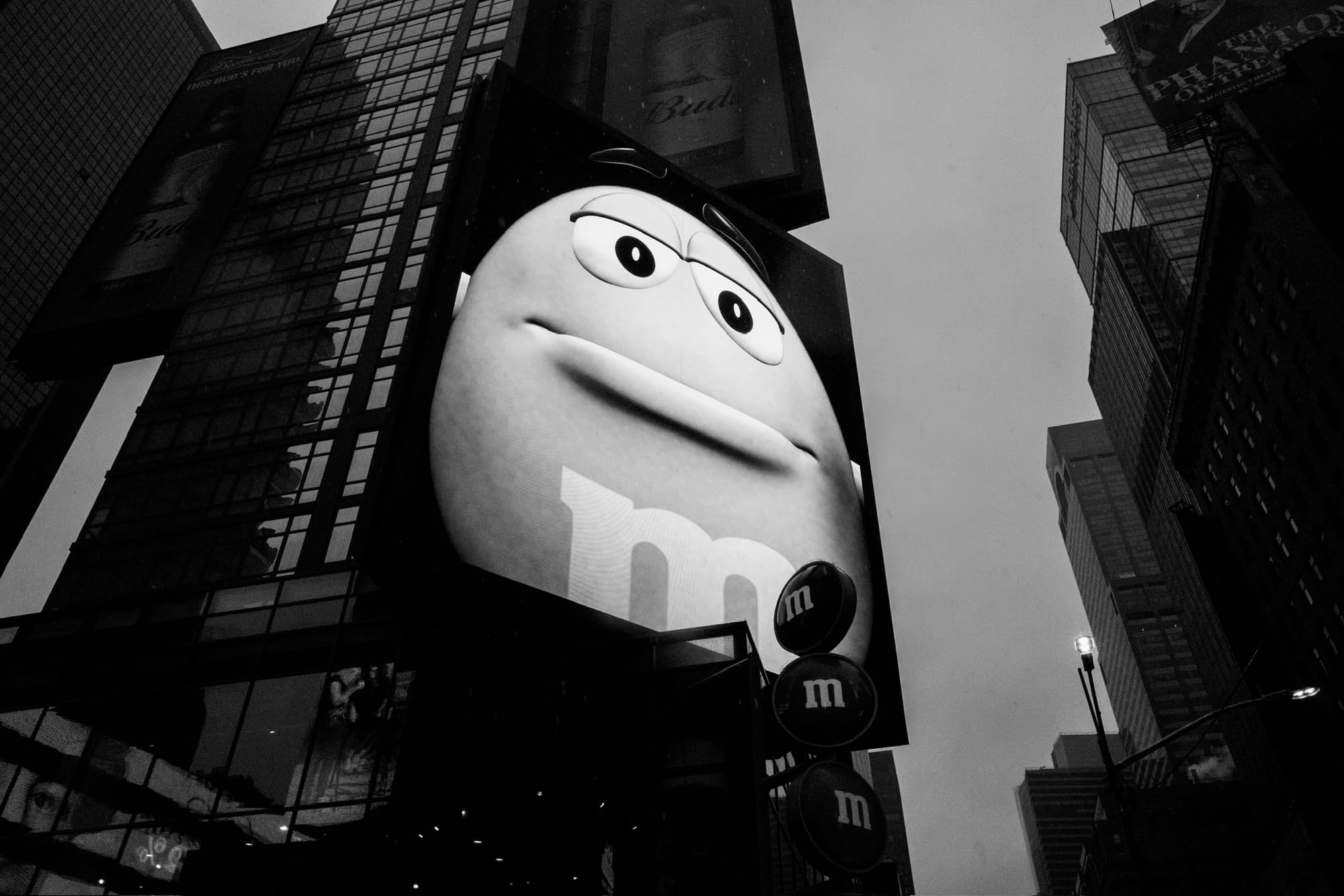 A giant M&M on a big screen looking like a dystopian overlord.