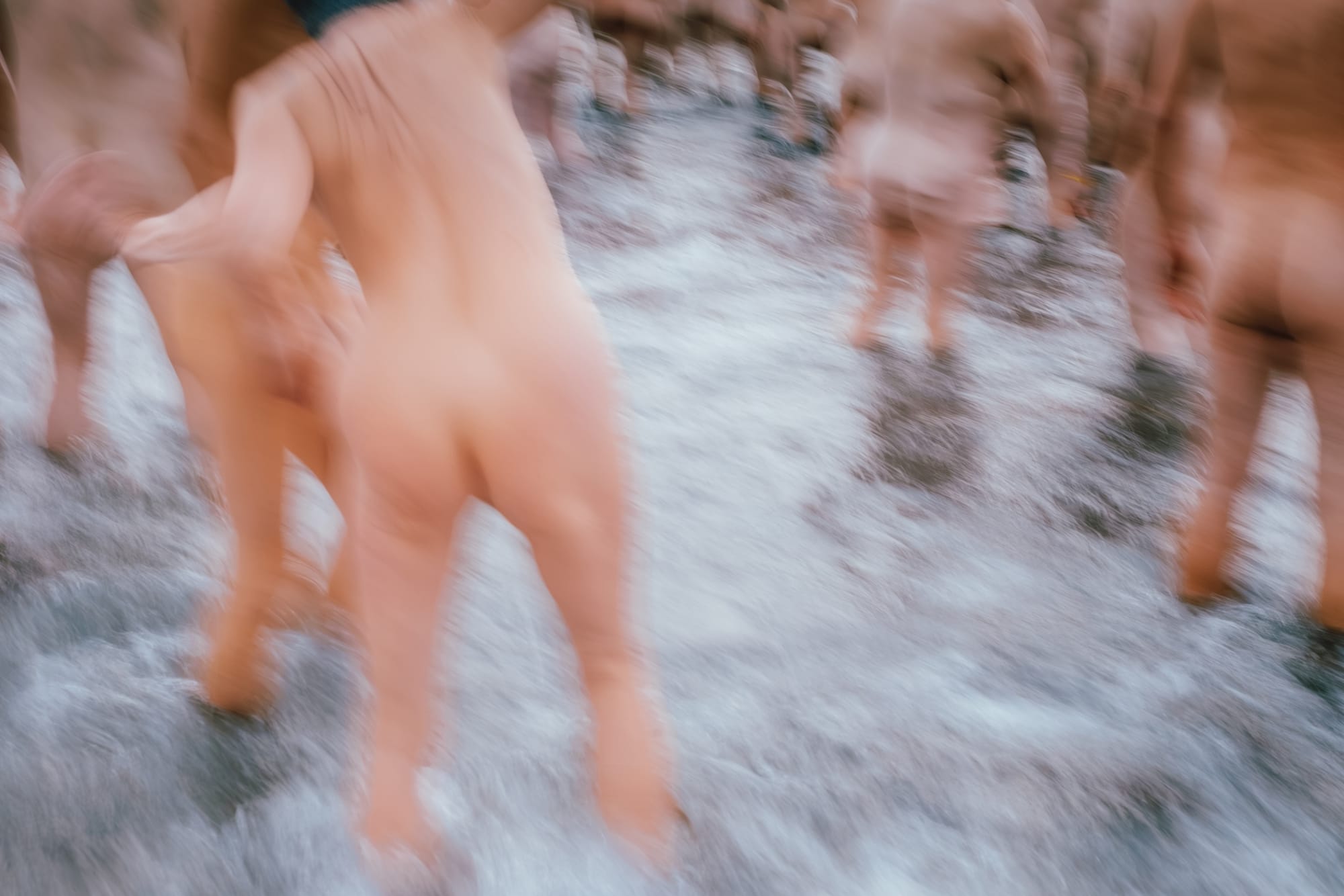 A blur of water and naked bodies as people waded out into the sea.