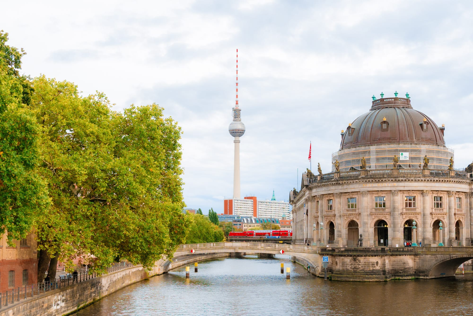 A picture of the Bode Museum in Berlin, Germany, with the Berliner Fernsehturm in the background.