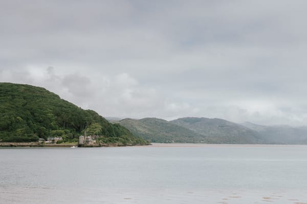 An overcast day at Barmouth Estuary. Hills lead off into the distance.