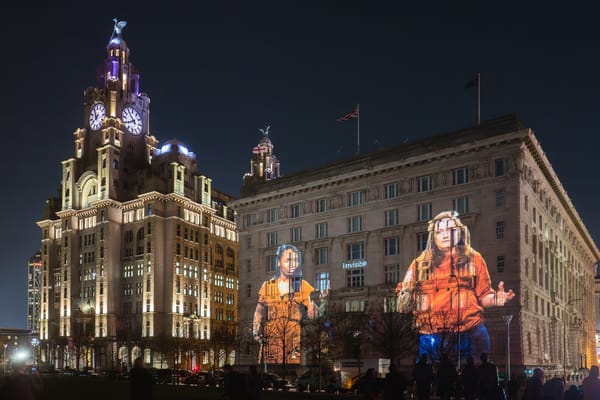 Projection of women on the Cunard building at night