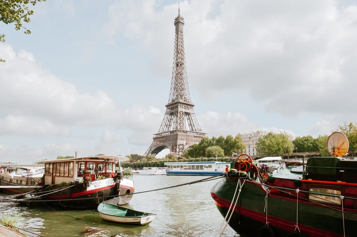 The Eiffel Tower stands tall above the River Seine in Paris.