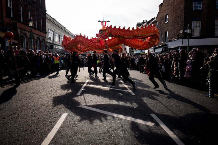 A Chinese dragon performance in the middle of the street.