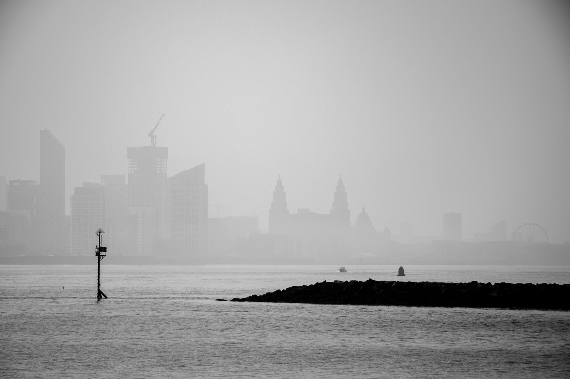 The skyline of the city of Liverpool silhouetted on a hazy day.