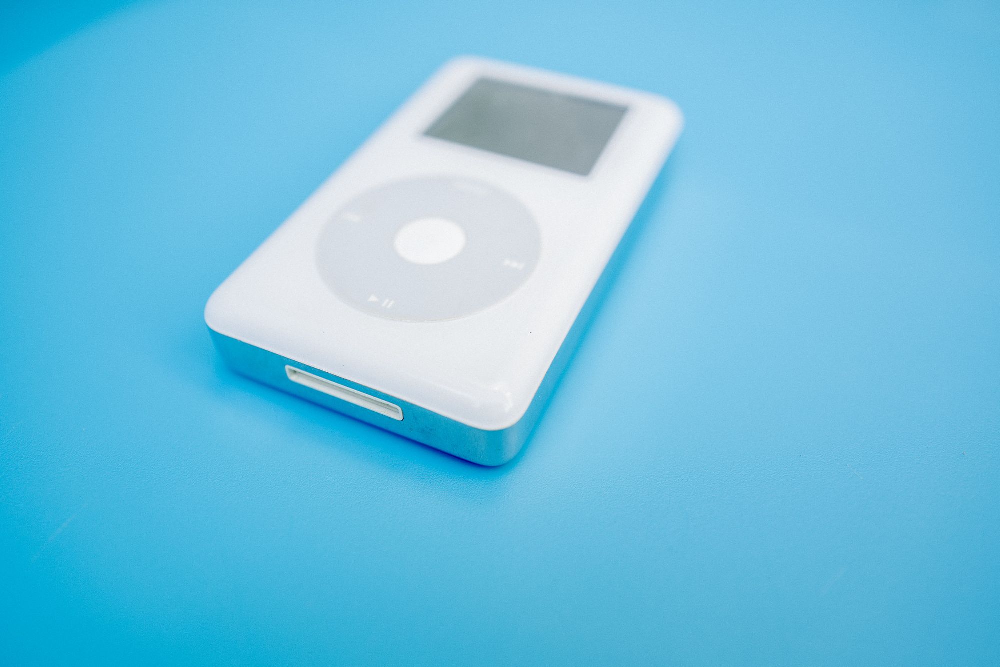 iPod click wheel lying flat on blue background
