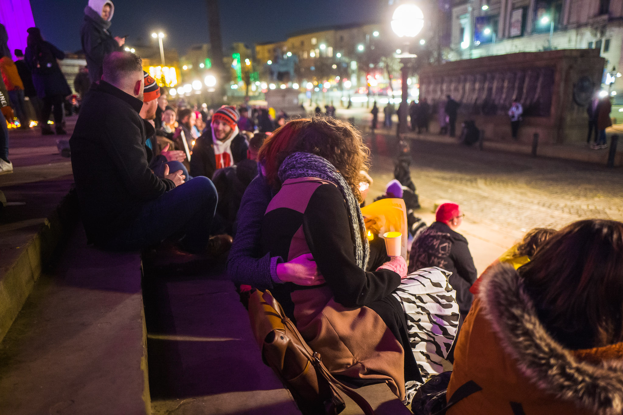 Two women hold each other tight during a vigil.